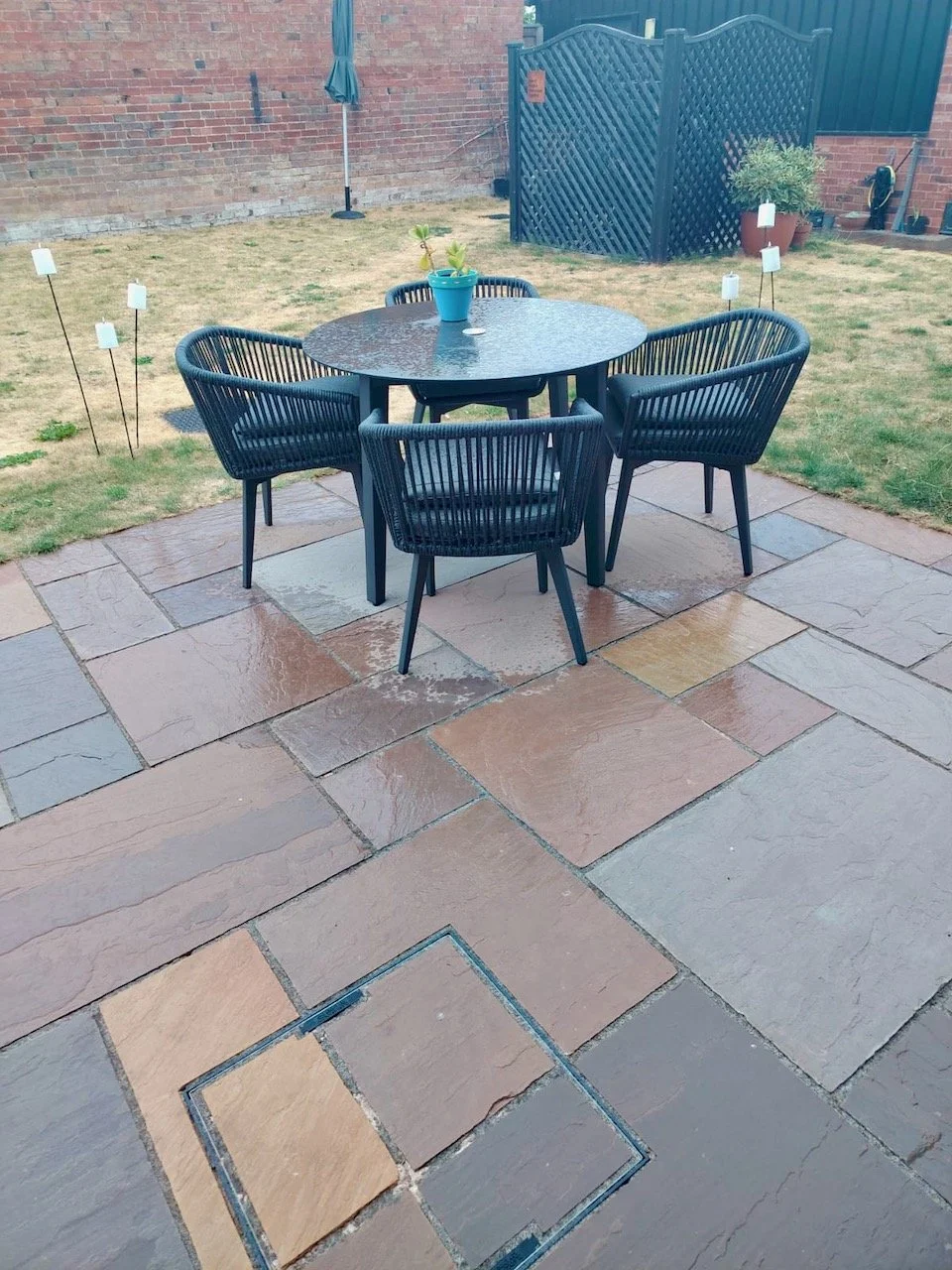Light rainfall on the patio and garden furniture