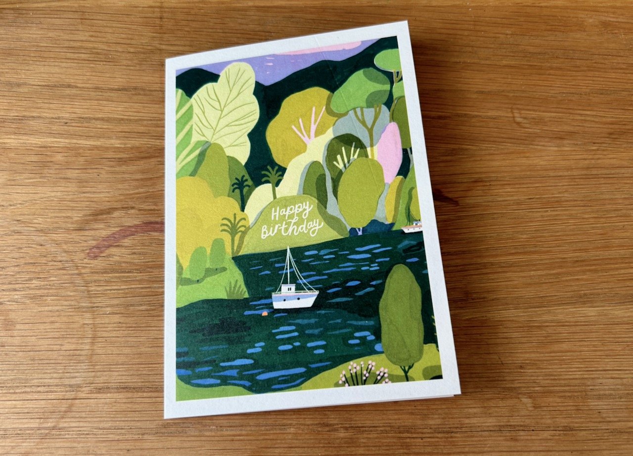 A BOAT BOBBING ON A LAKE IN A RICHLY VERDANT HAVEN