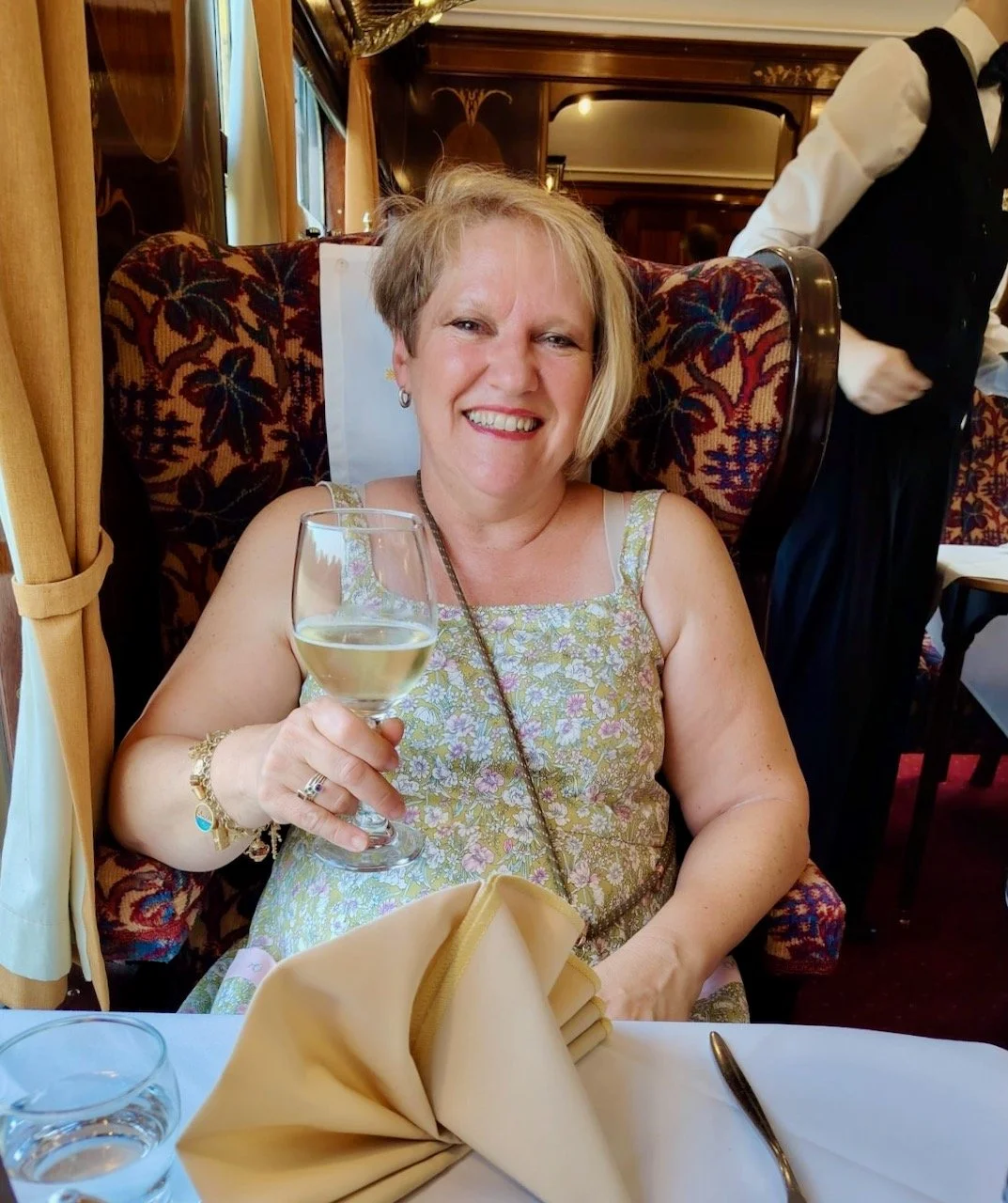 Me on the Bluebell Railway wearing the dress and enjoying a glass of white wine