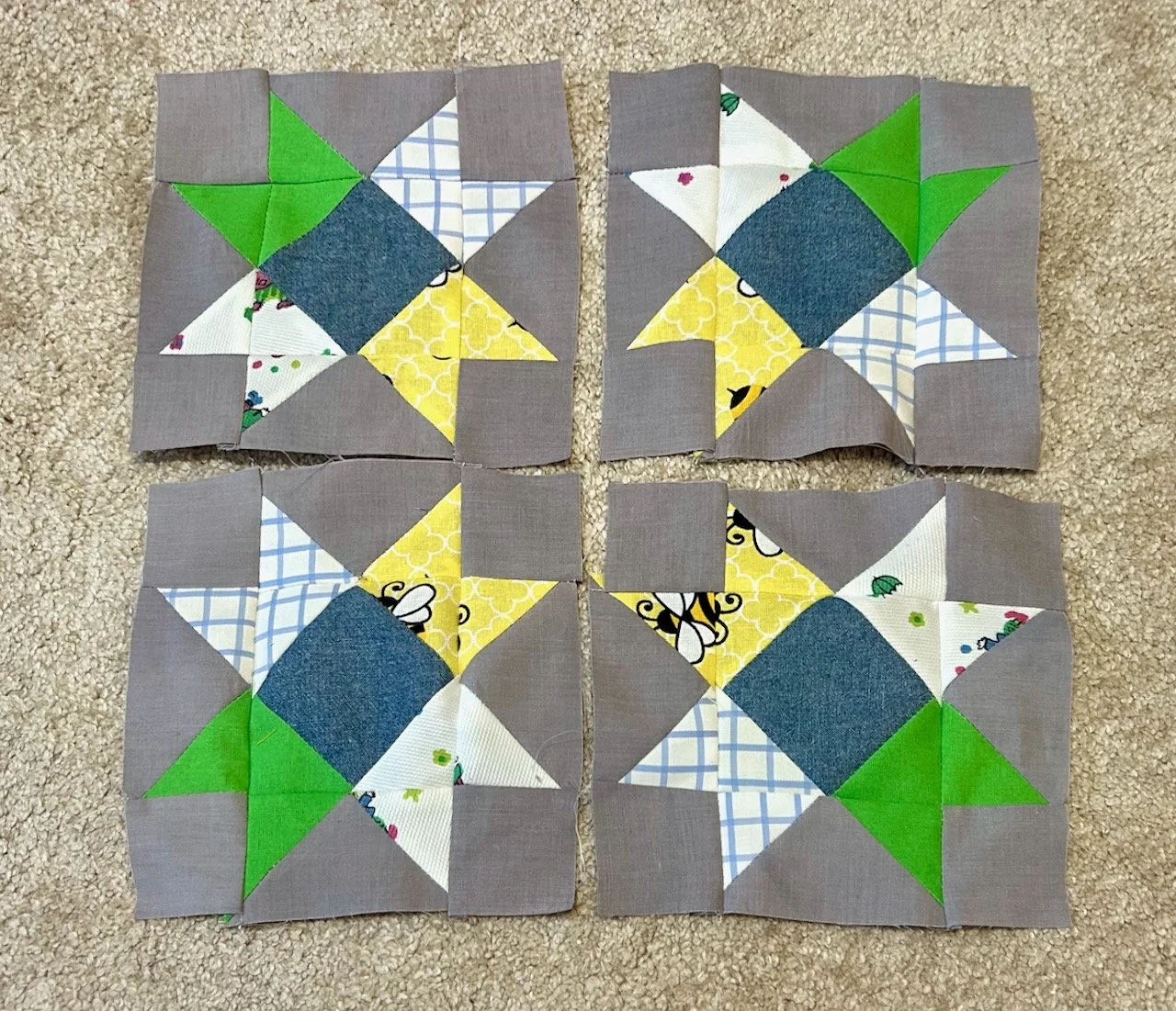 The four 'star' central blocks sewn together and laid out in a grid formation