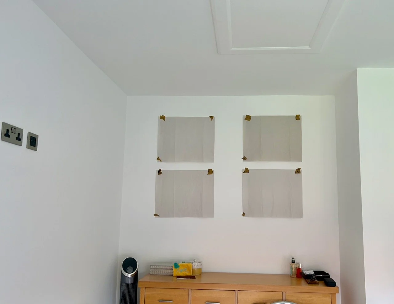 4 sheets of paper taped to the wall to test if the layout worked