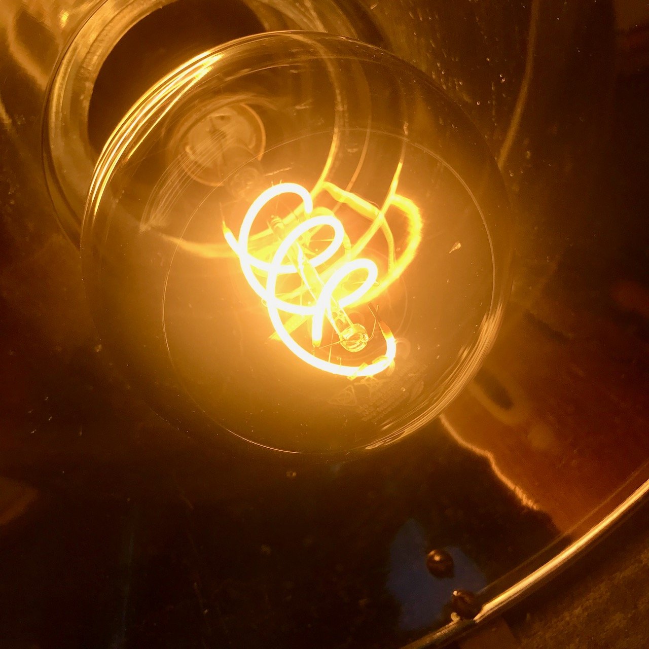 The yellow lit filament of the bulb