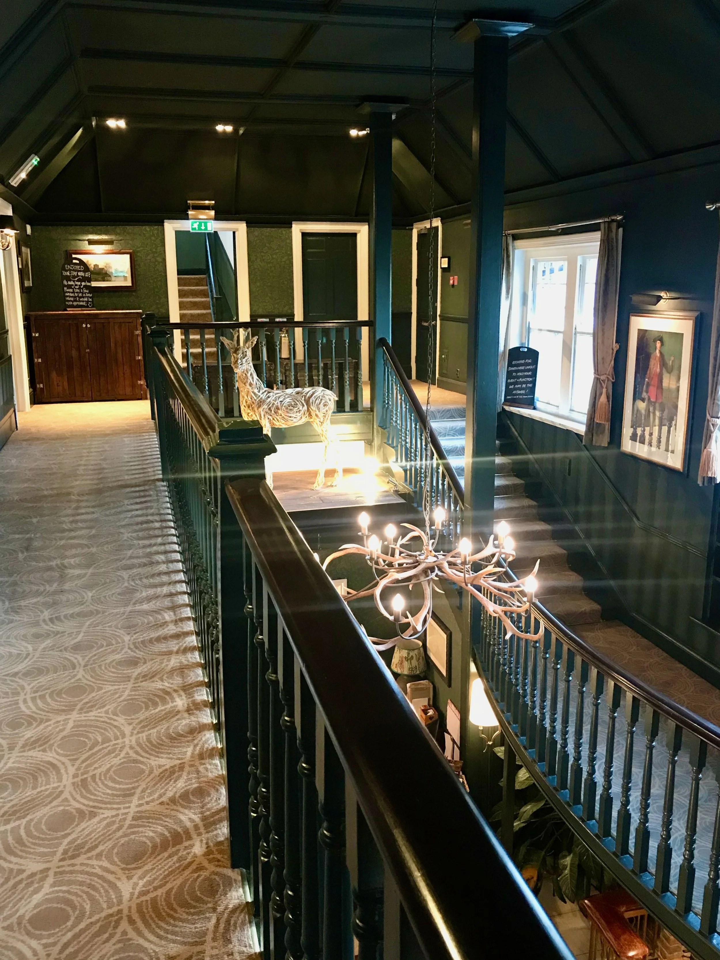 A statue of a deer above the reception and an antler light