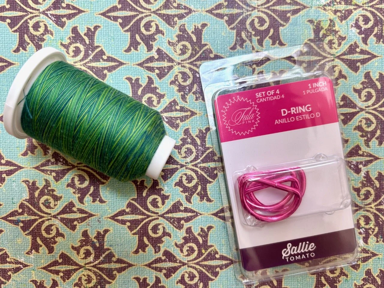 Blue and green variegated thread and a pack of pink D-rings for bag/pouch making
