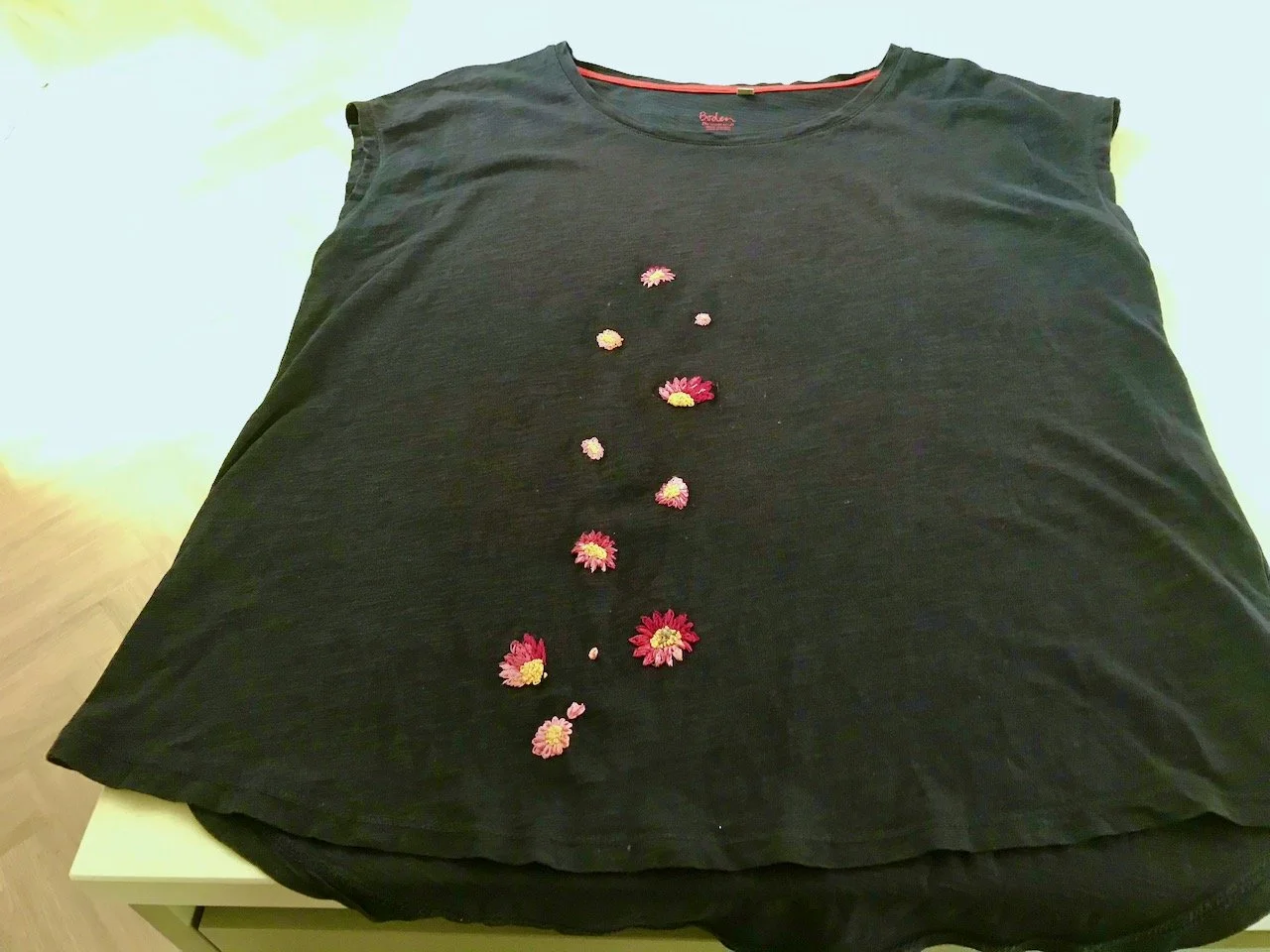 The t shirt laid out to show the embroidered sunflowers which have now migrated up the top (I liked them so much)