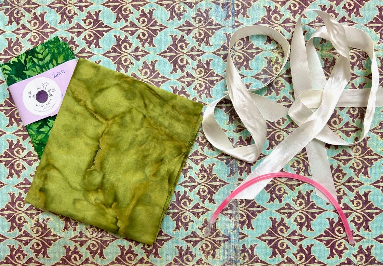The wedding bundle: two green fat quarters, plus ribbon and a spent glow stick from the wedding favours