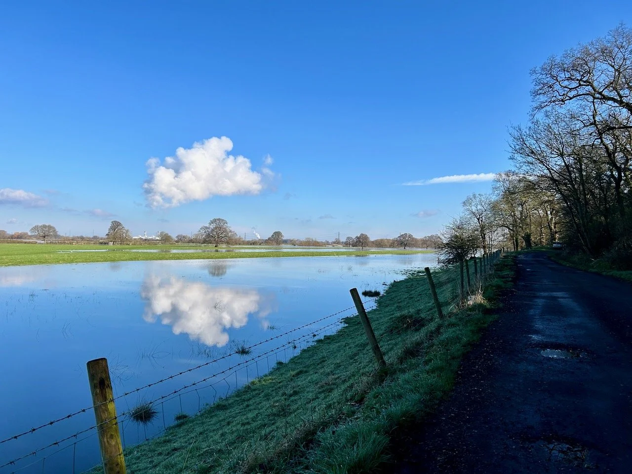 A CLOUD REFLECTED IN THE NEWLY FORMED SECOND RIVER ALONGSIDE CHURCH LANE