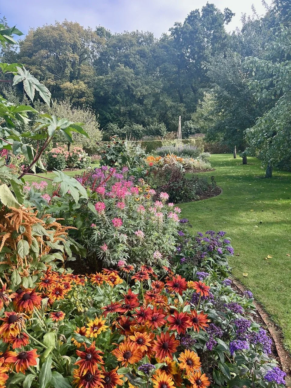 Entering into the Cut Flower garden with circular beds in the centre of the garden and orchard trees on the edges of the space