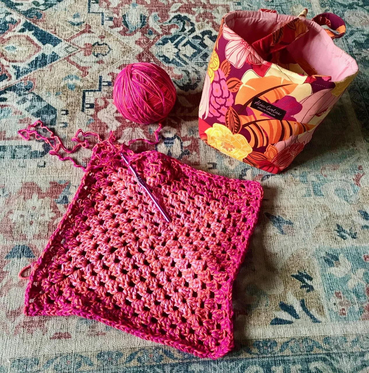A quick growing granny square, the unwound project as a large ball and my unintentionally matching project bag