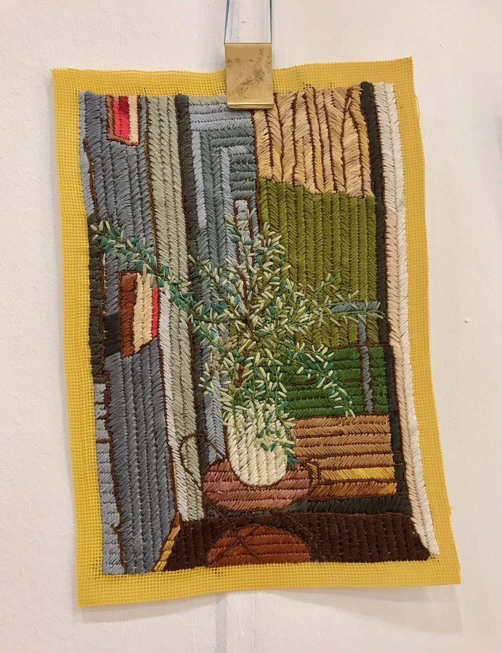 A closer look at tone of the embroidered room scenes