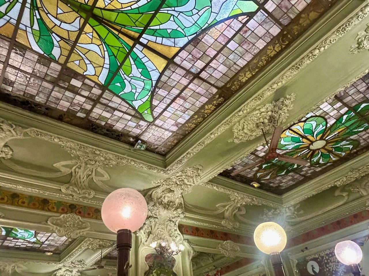 Looking up to the ceiling again, but also admiring the pale green surrounds and bulb lights