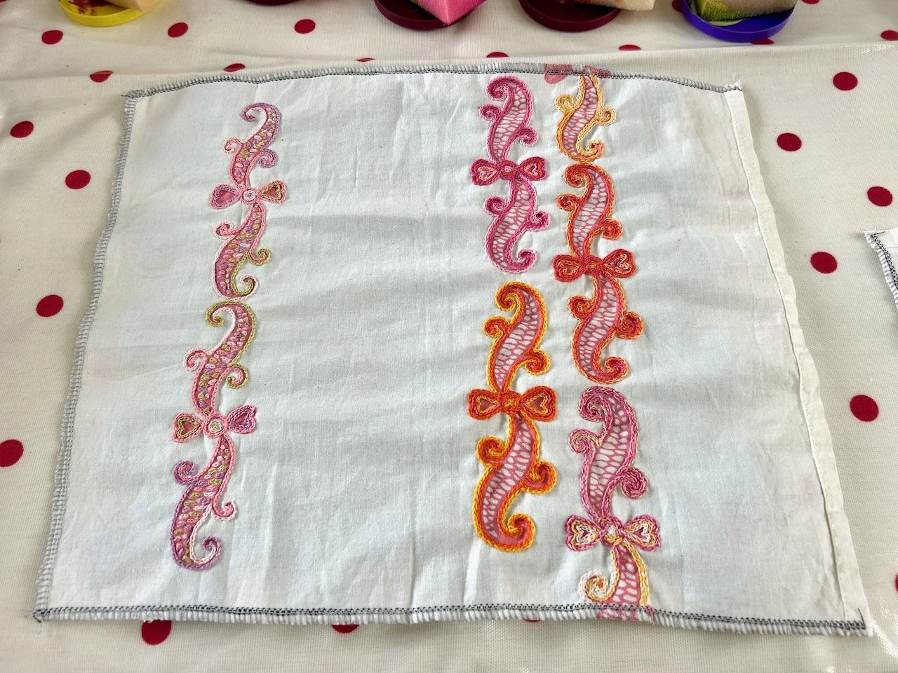 All three rows of swirls are now embroidered, the piece is on the spotty oilcloth ready for more printing