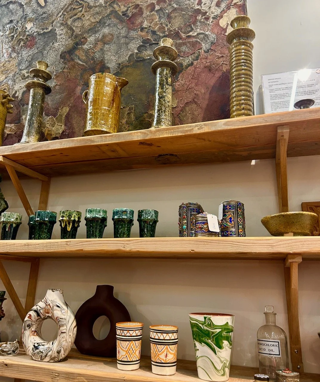 Two shelves of ceramics - candlesticks, jugs and beakers