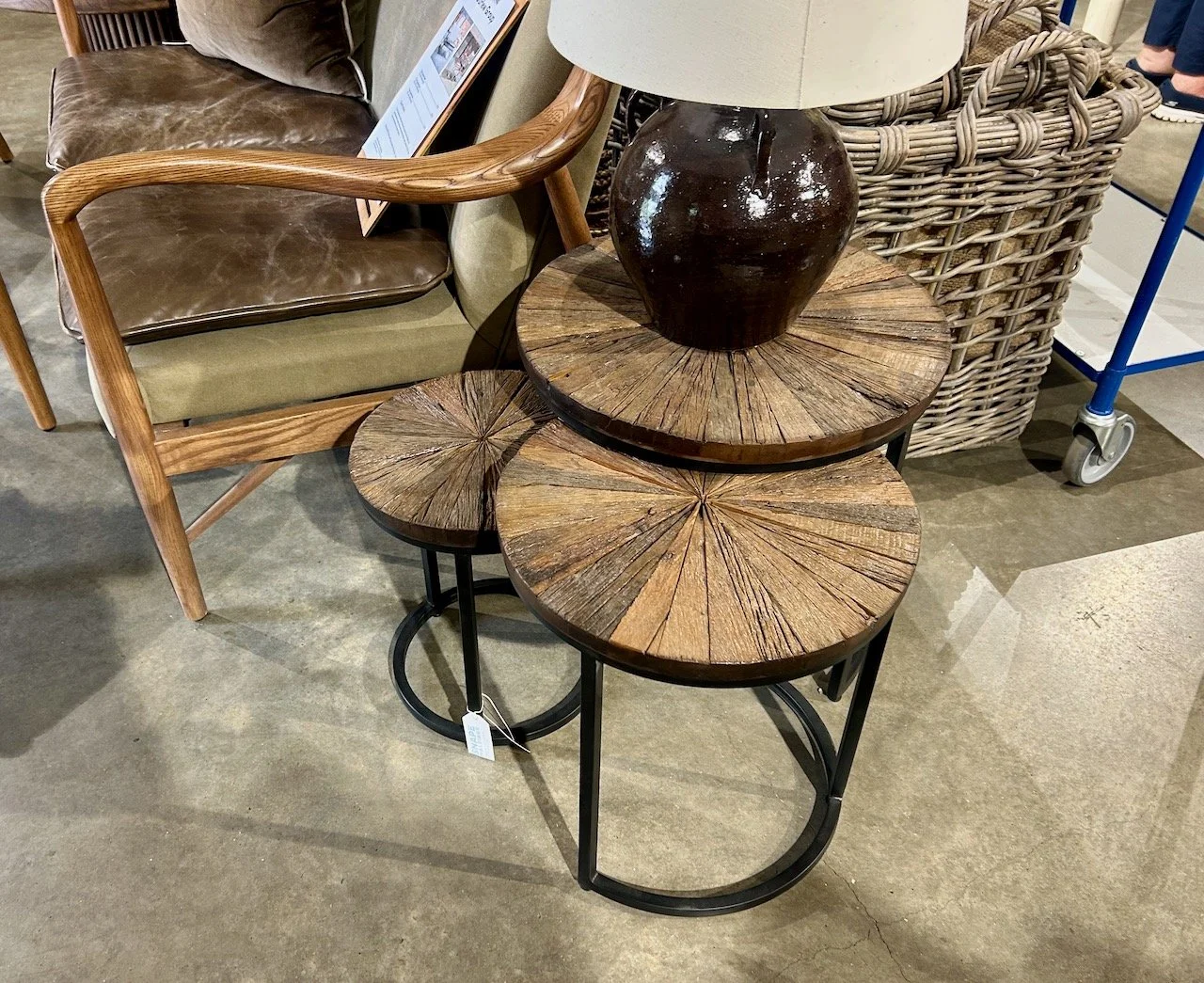 A set of three nested tables with a wooden top