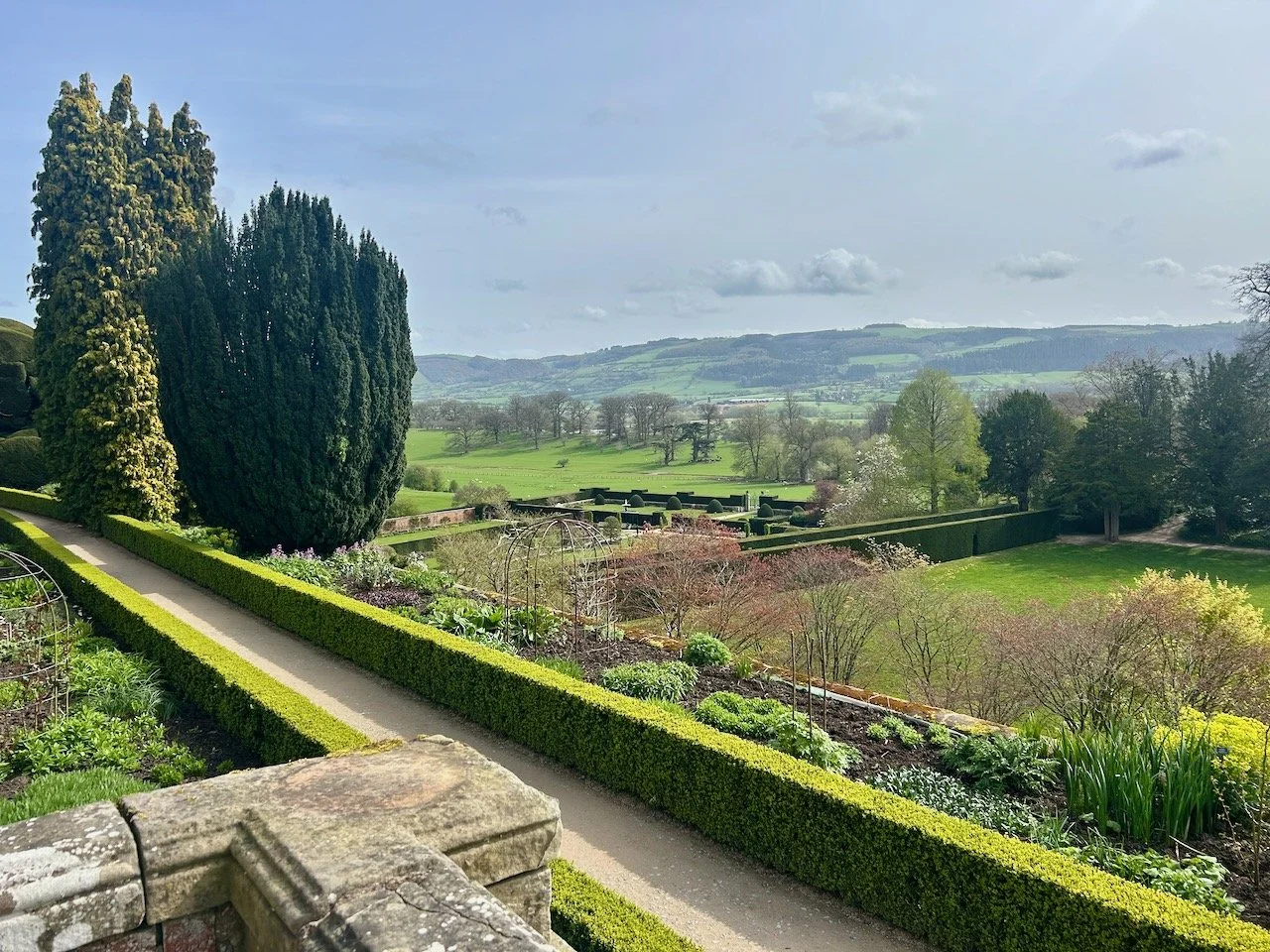 The view from the terrraces at Powis Castle across the gardens below and countryside beyond.
