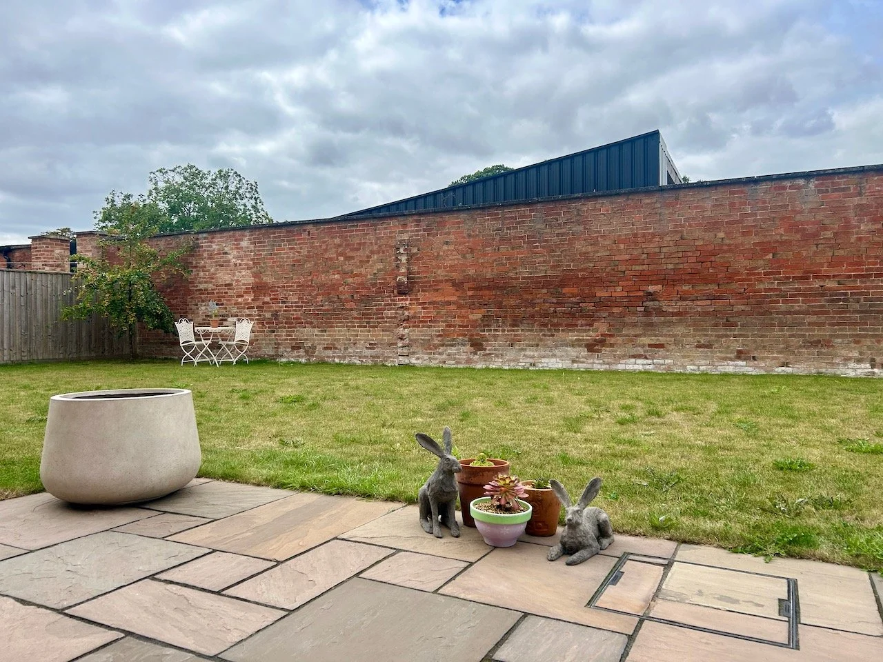 Looking across the patio to the large pot in its corner - checking the position is right