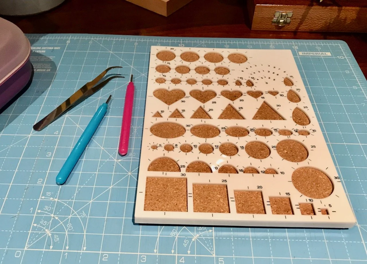 Tweezers, quilling tools and a cork backed guide
