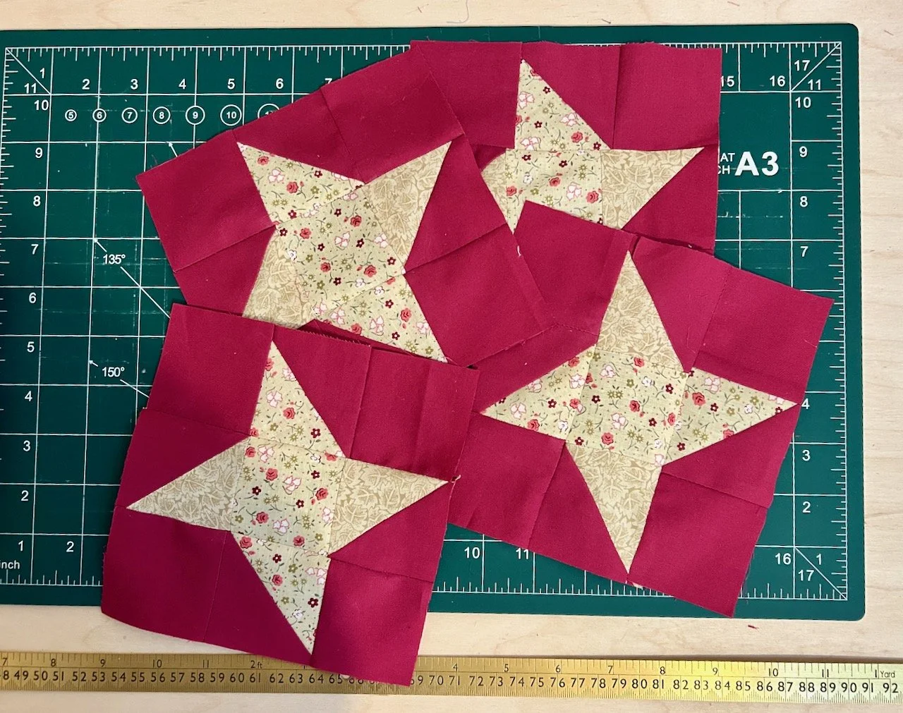 The four central blocks - caramel stars surrounded in a plain raspberry fabric