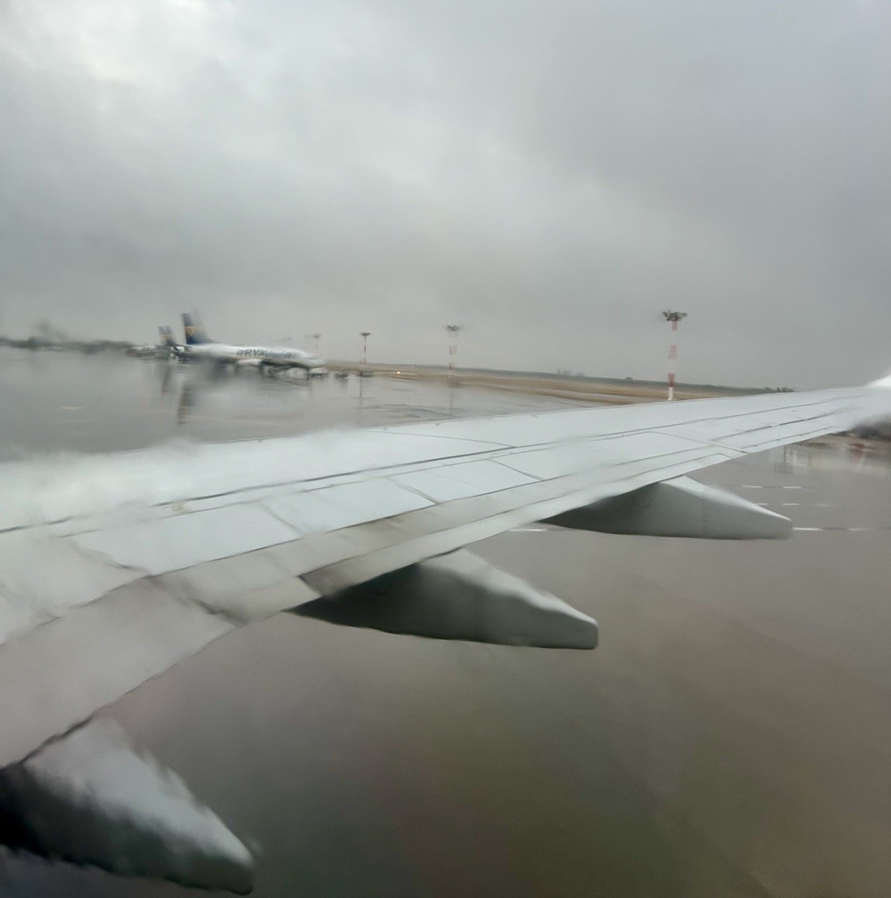 A grey wet landing at Bari airport from the window of our plane