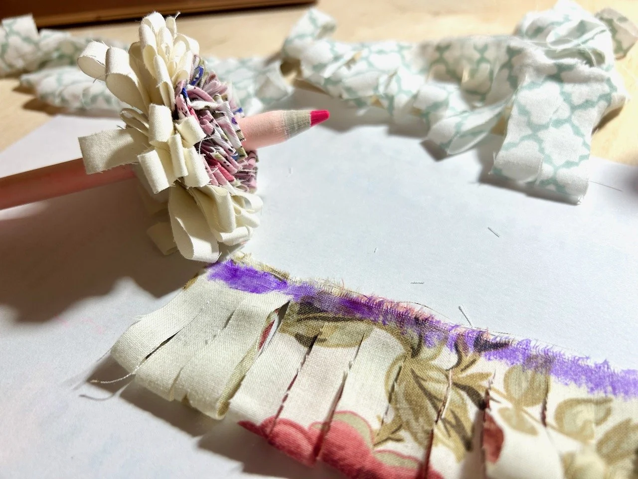 Showing the purple glue on the second strip, rolling in progress