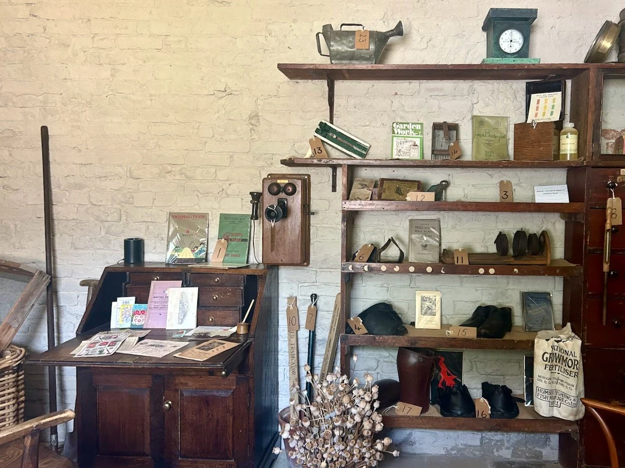 The open shelves with a wooden bureau in the Head Gardener's Office at Scampston Hall