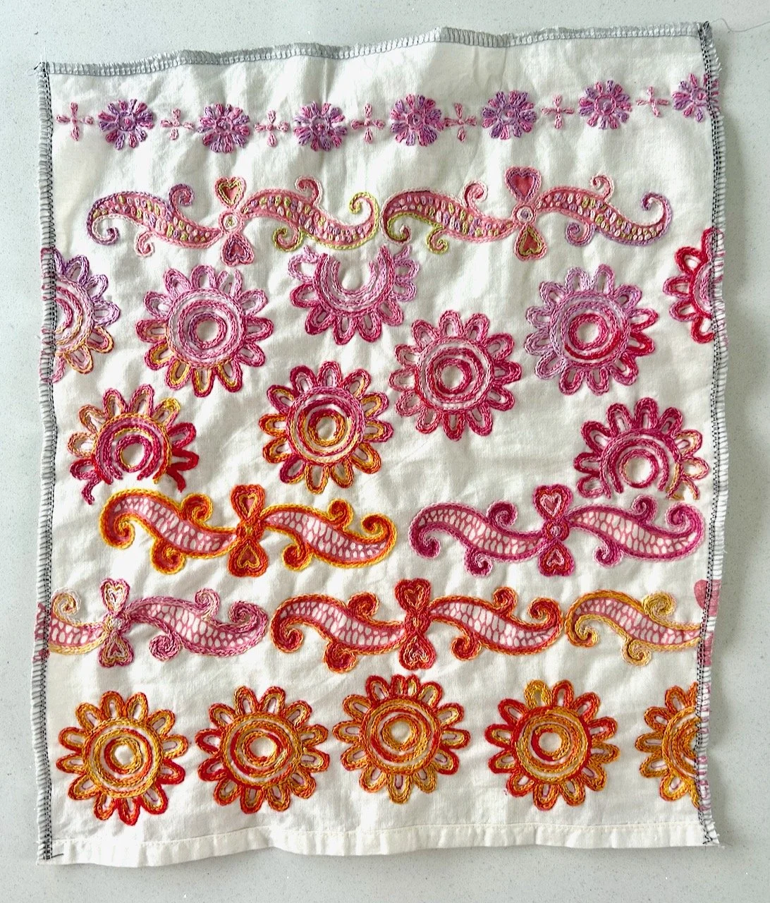 The finished piece lighter pinks at the top graduating to brighter pinks and then oranges at the bottom