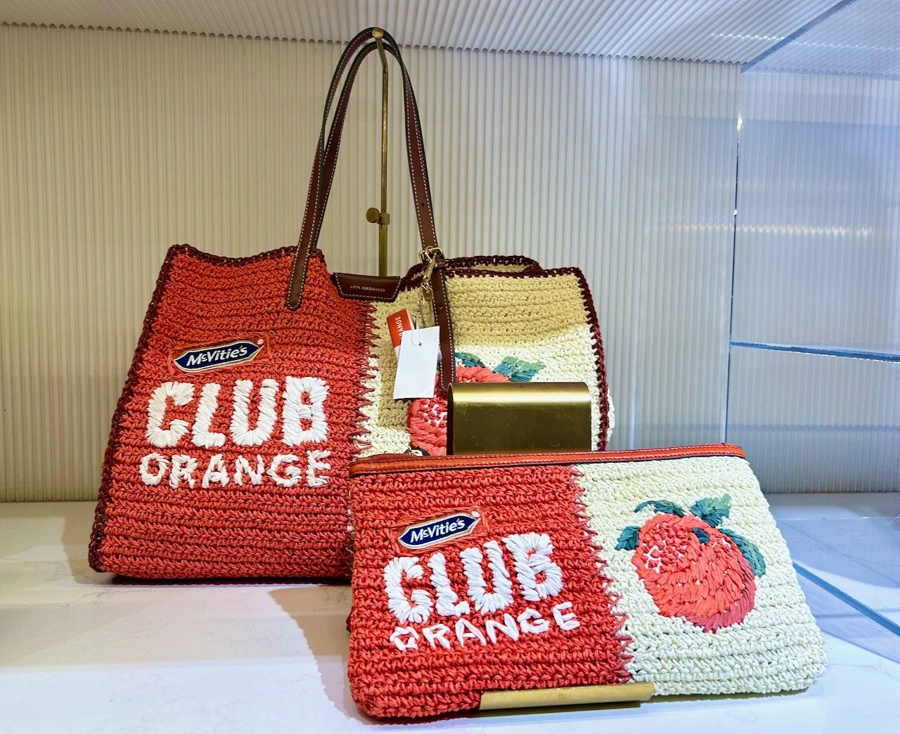 A tote and clutch bag replicating the McVities Club Orange in raffia