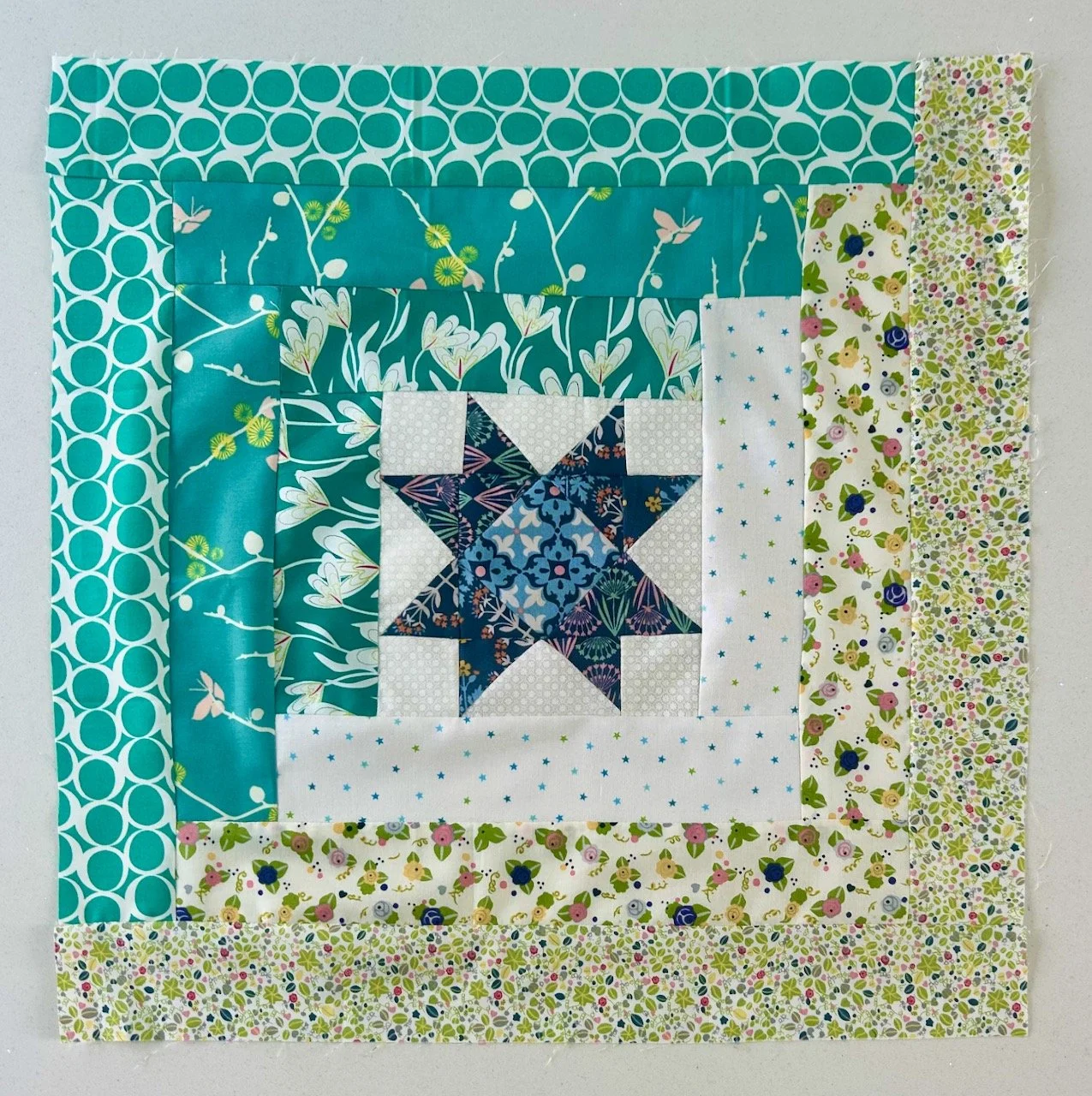 The completed block with borders - the original green borders on the top and the neutral borders on the bottom (these remain constant throughout the quilt)