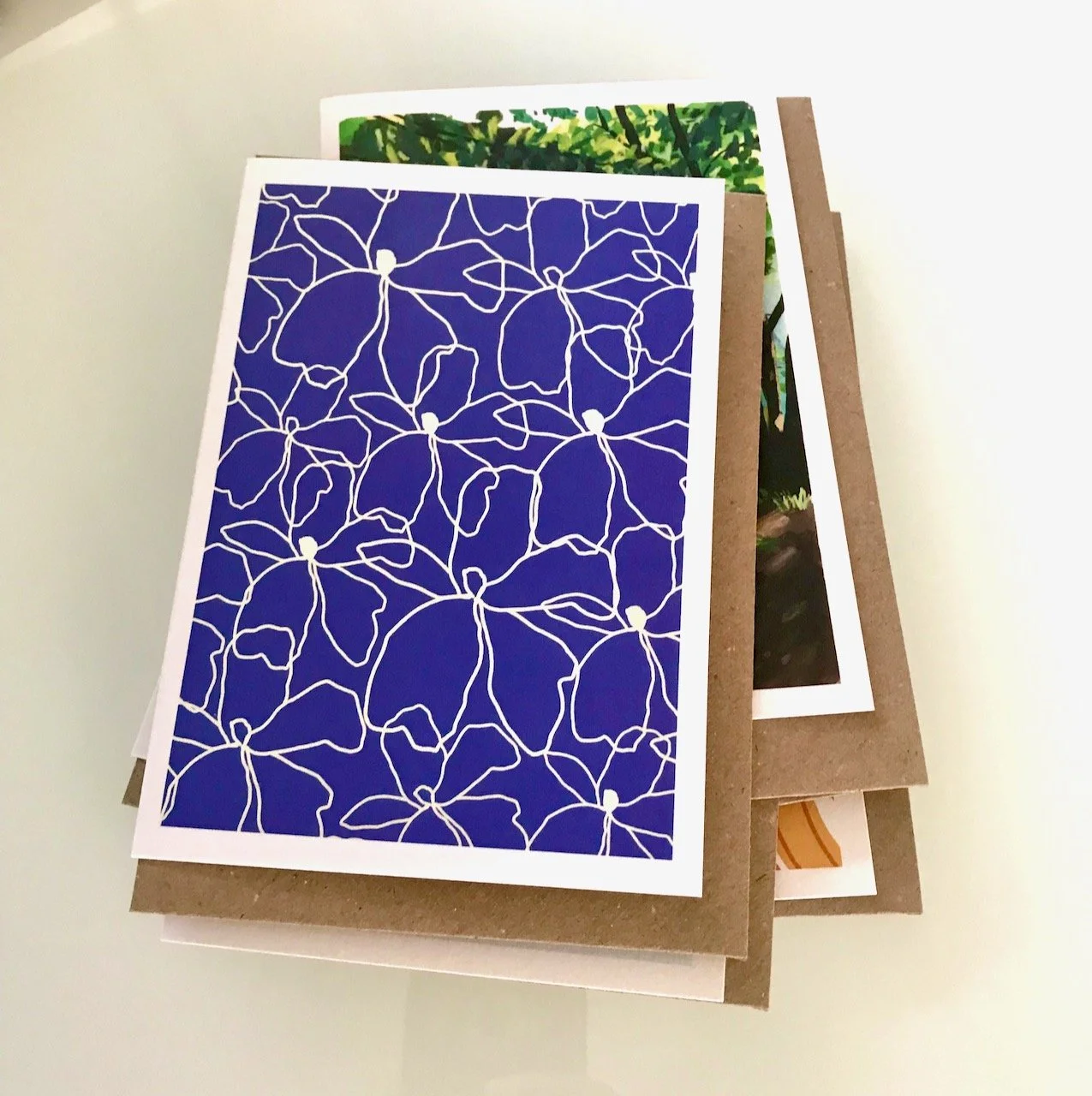 WHITE ABSTRACT FLOWER PATTER ON A MID BLUE BACKGROUND