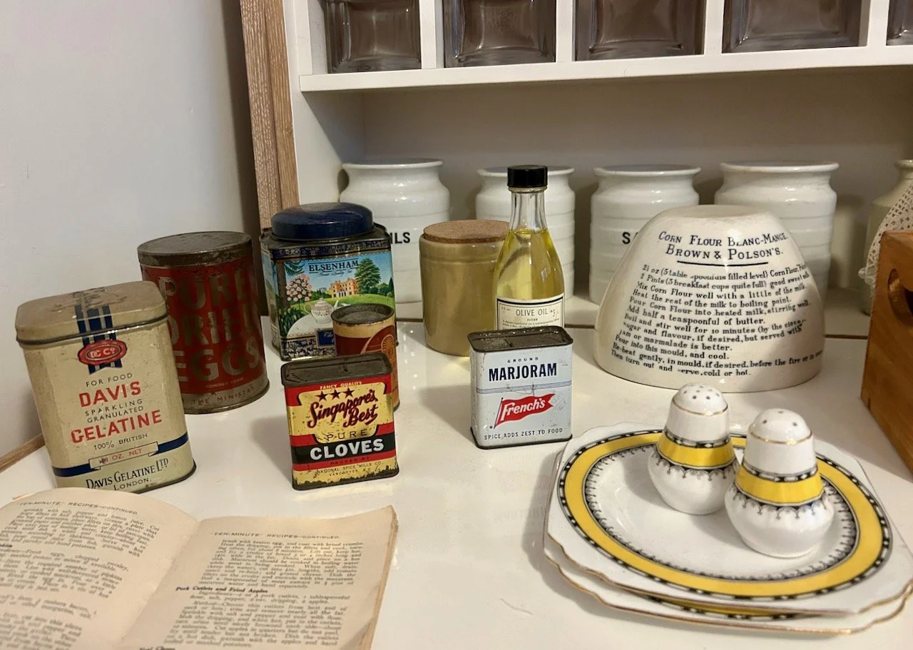 A display of kitchen ware and vintage tins