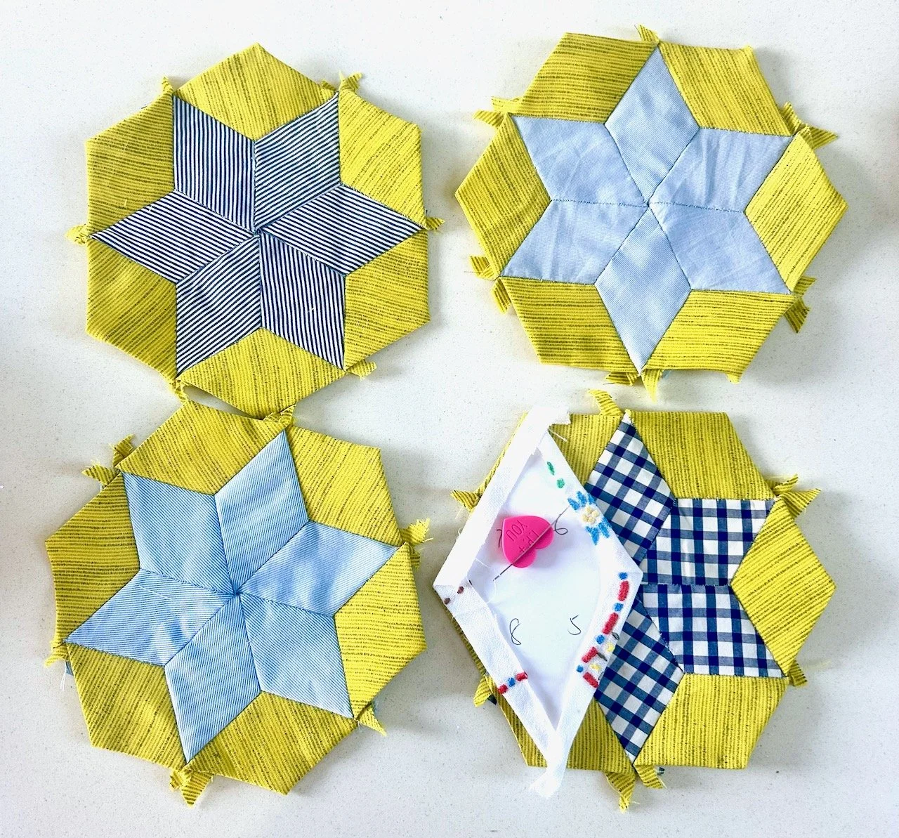Four of the blue and green diamonds sewn together - with a larger diamond being sewn in the centre
