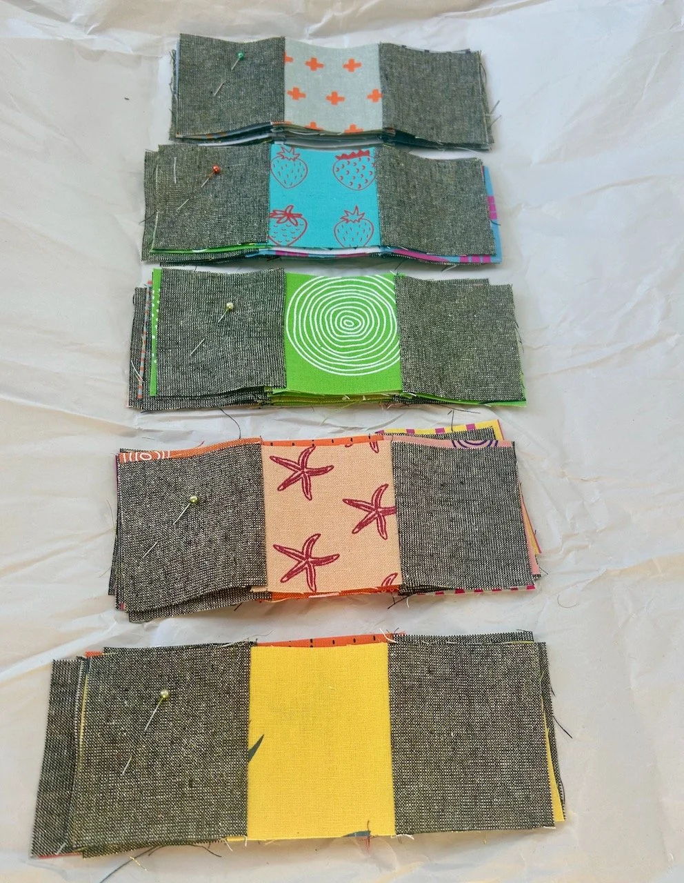 Piles of blocks part sewn together to ensure the sewing matches the thinking