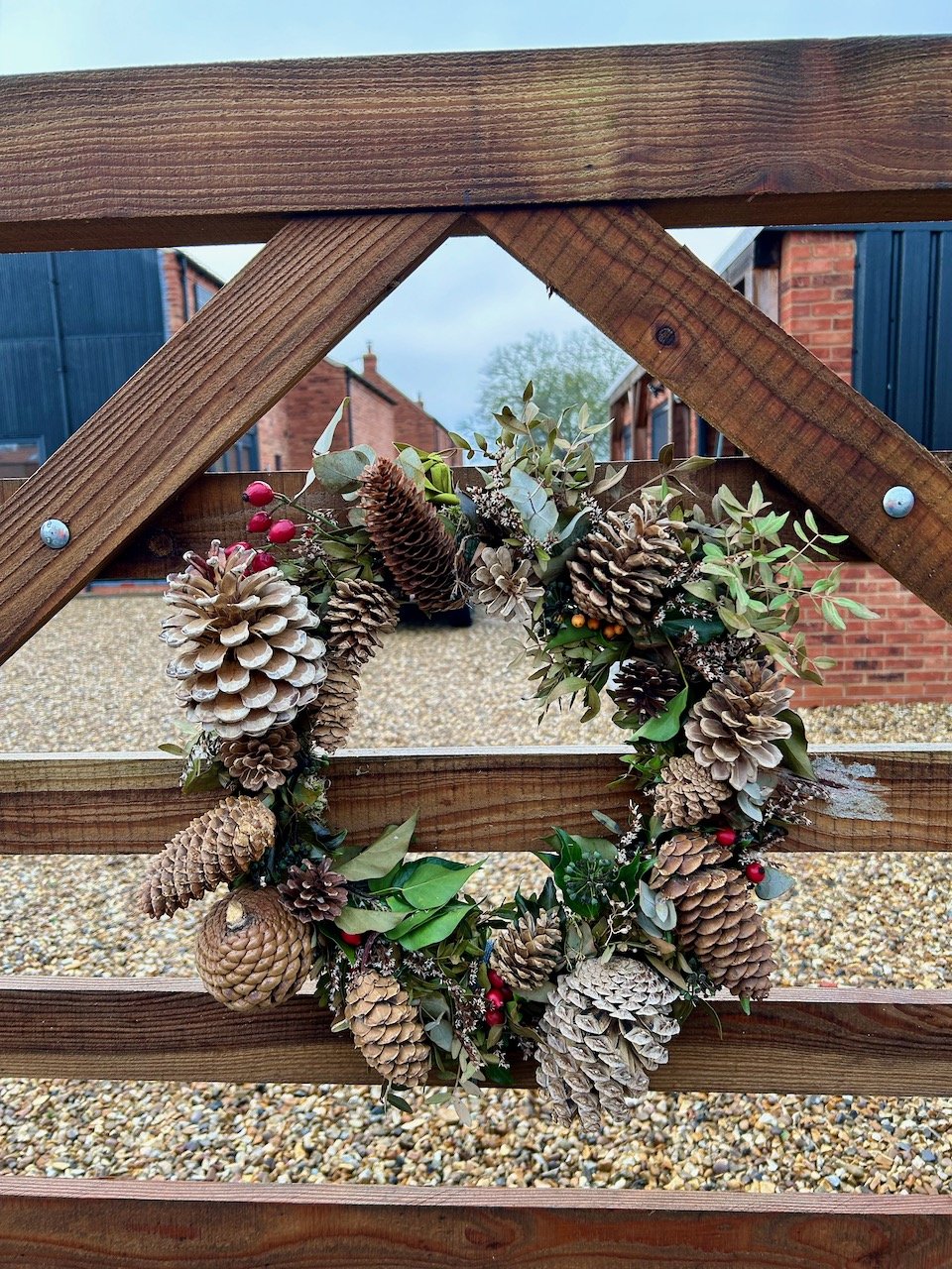 The primped autumn wreath with newly acquired pine cones attached to our gate