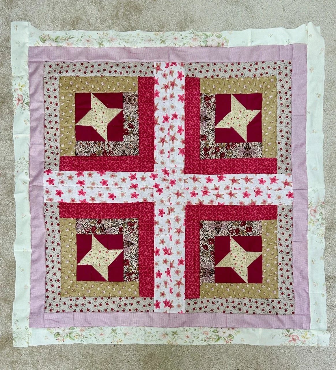 The four block quilt top sewn together with a cream border added (it was an old pillowcase)
