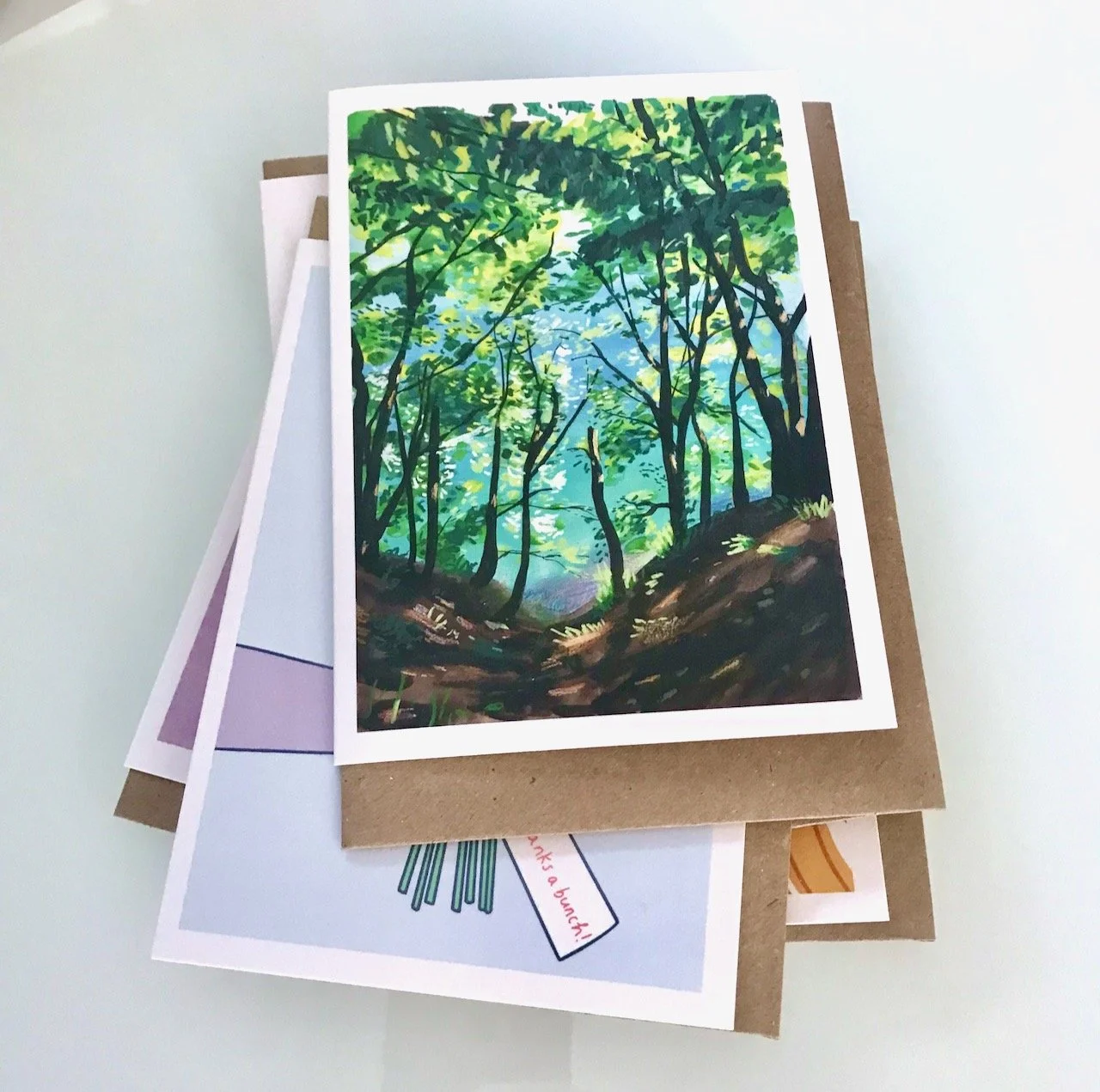 LOOKING THROUGH A WOODED LEAFY LANDSCAPE INTO AN OPENING