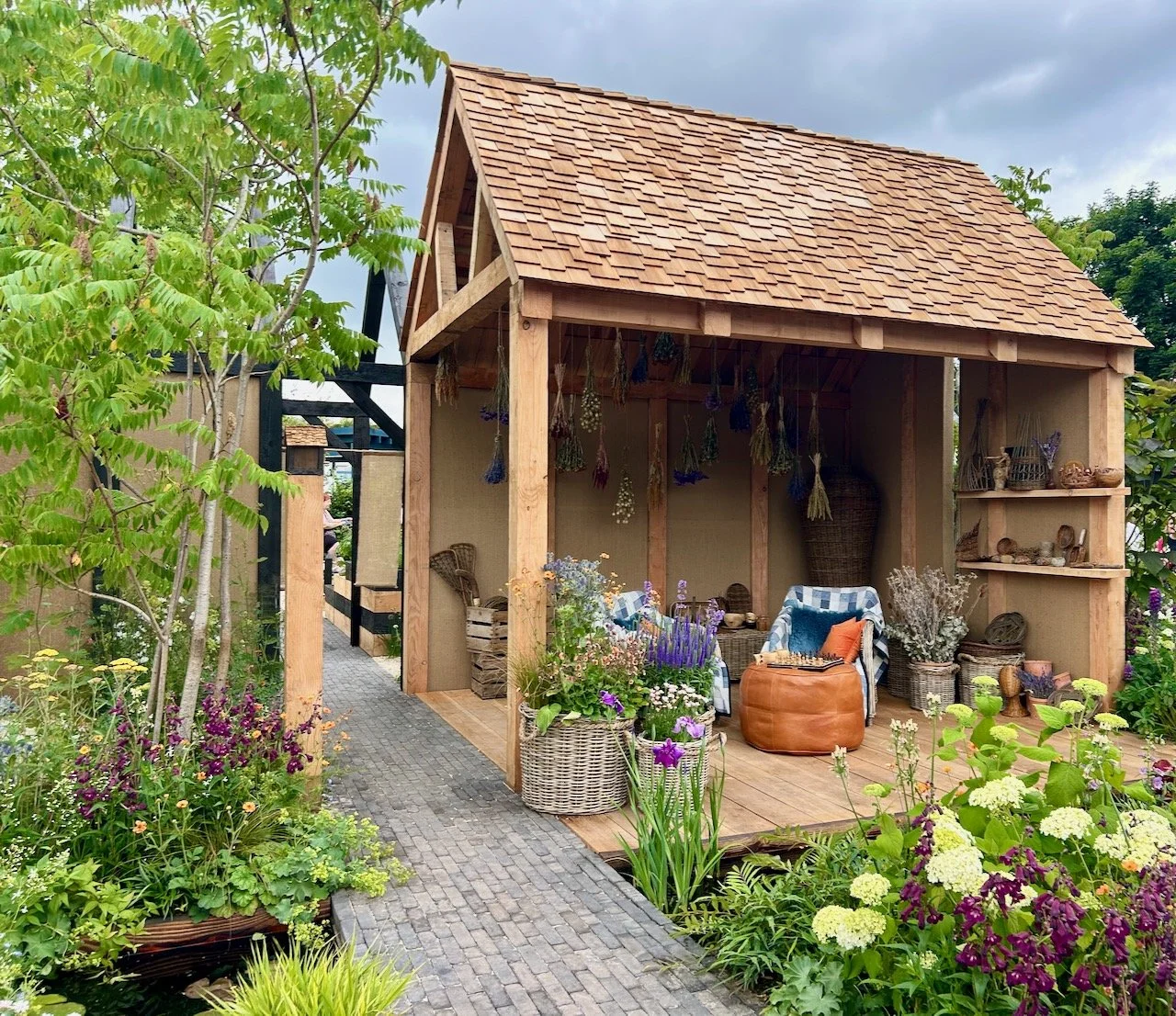 The open but covered seating area with cosy chairs, patchwork throws and a game of chess