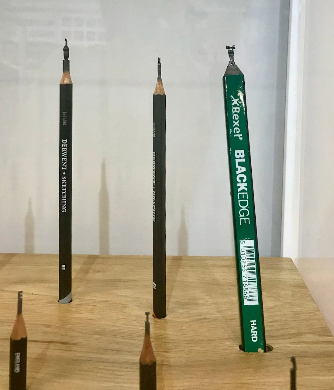Tiny sculptures on the end of the pencil tip - including an acorn and a weightlifter