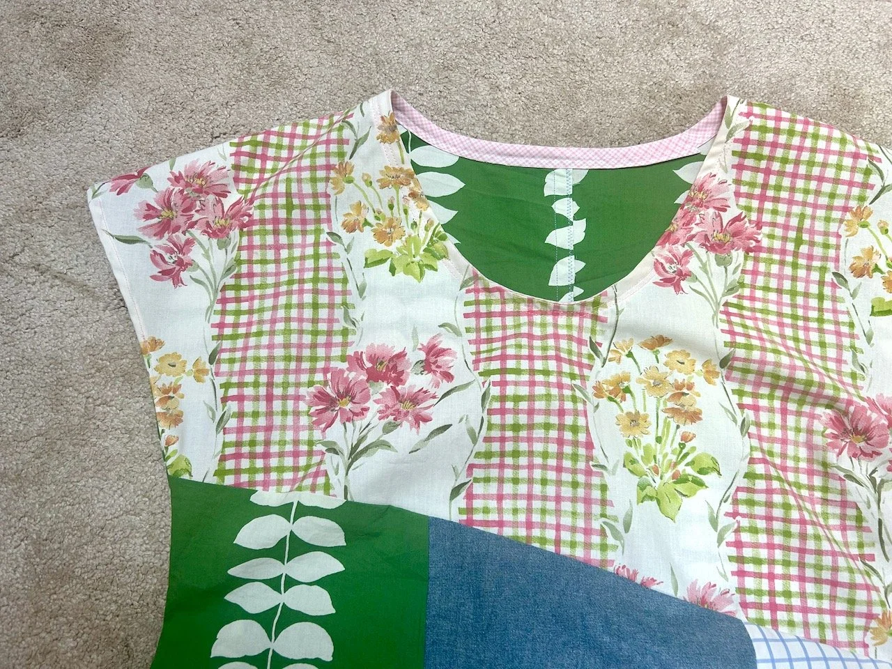 A CLOSE up of the top half and neck finished with pink bias binding - the back uses the green material