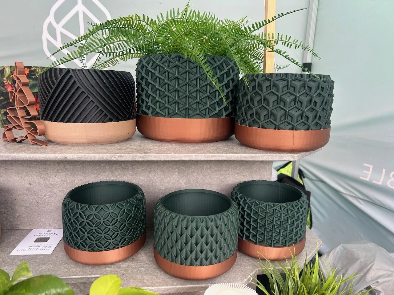 Planters in bottle green and copper - which I'd happily have all of