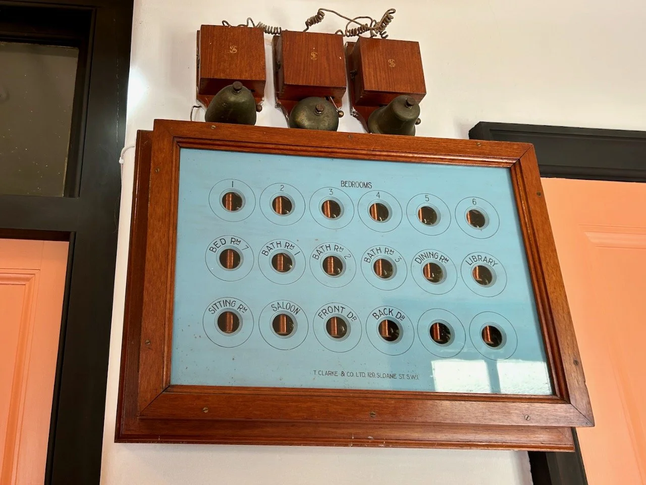 the downstairs 'bell system' hanging on the wall near the kitchen