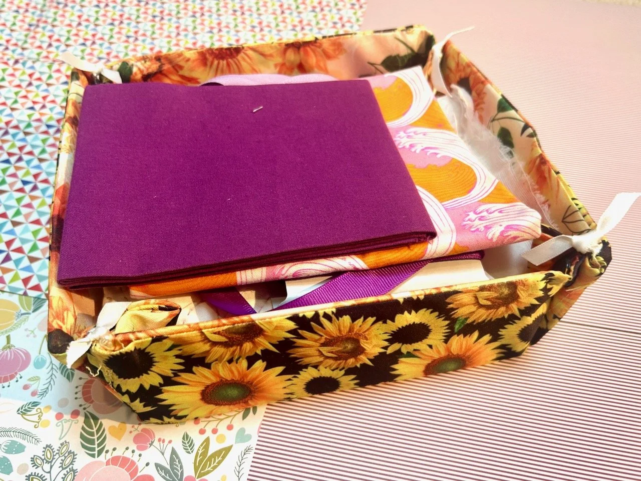 A fabric collapsible box/tray - complete with a project waiting to be sewn