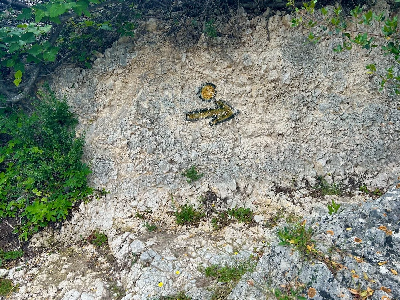 A large yellow and black arrow sprayed onto the rock - we'll go that way then