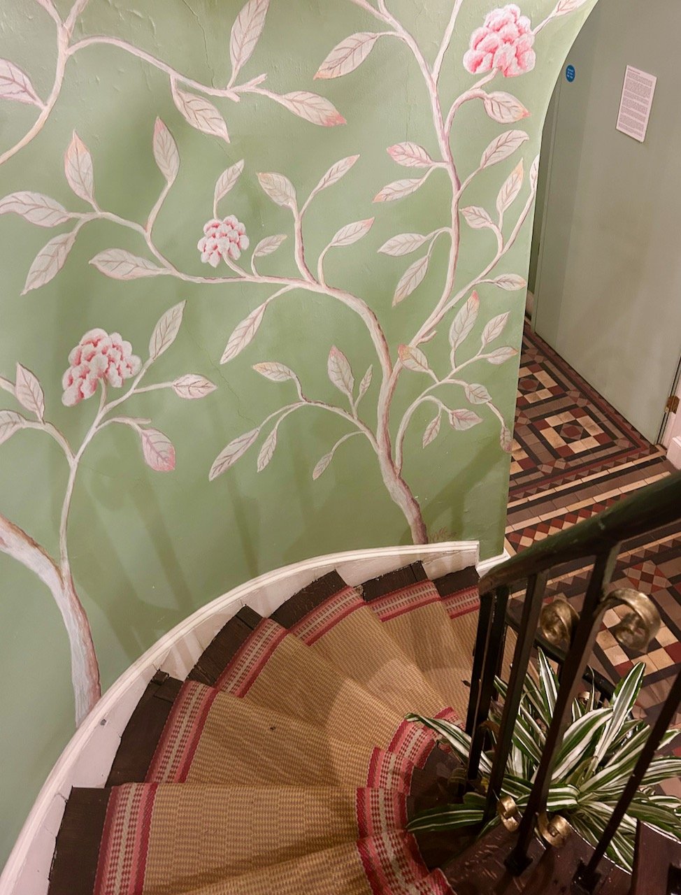 Pretty chinoiserie style wallpaper as we went down the circular stairs