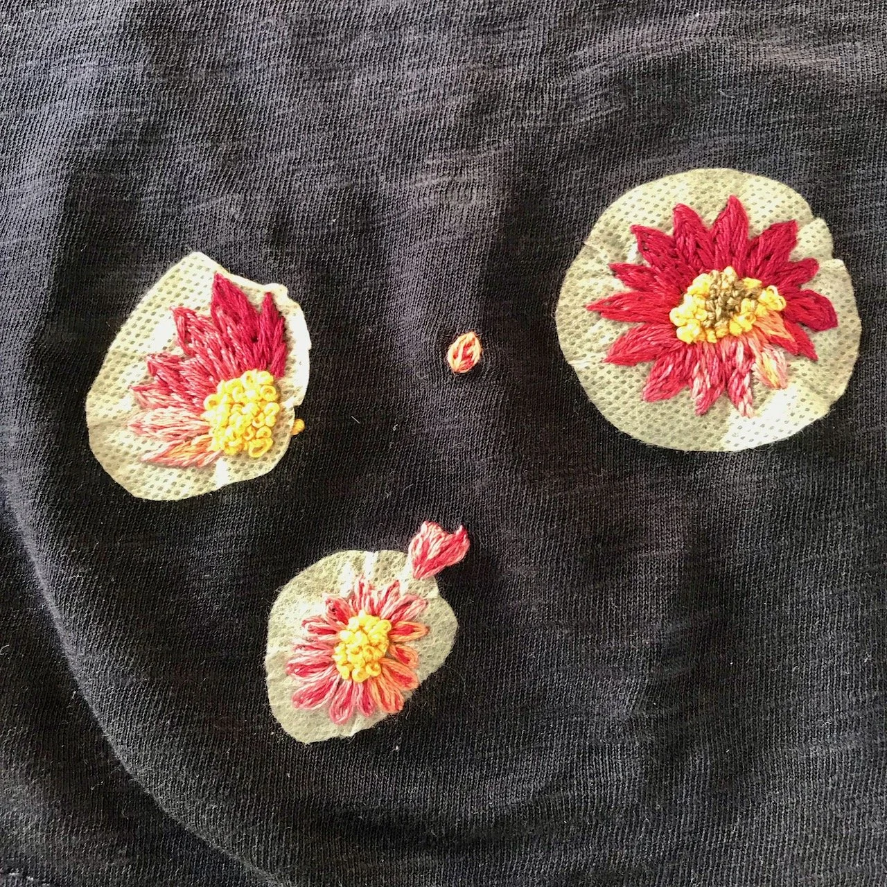 Making progress - three completed sunflowers - with the template sticky material around them