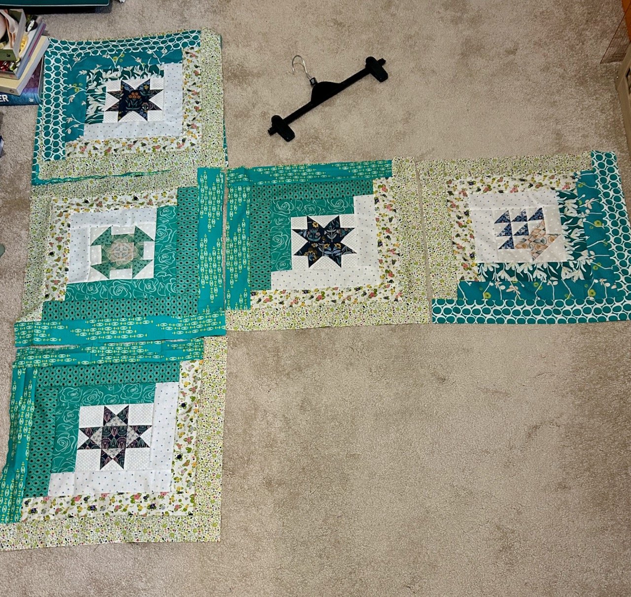 Checking my fabric choices alongside the blocks i've already sewn in the row above, horizontally and vertically