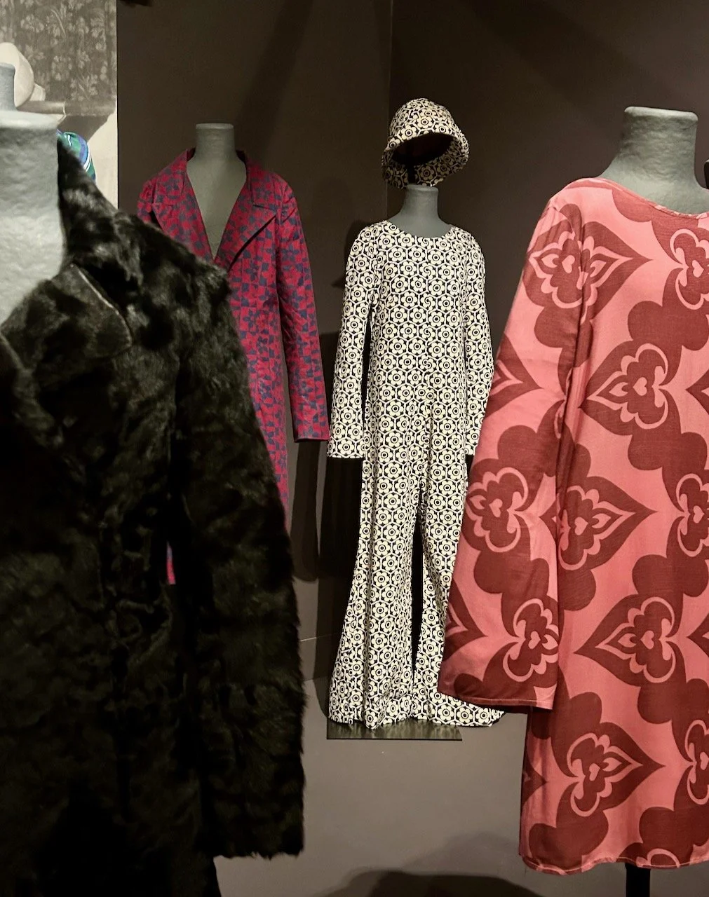 At the centre is a black and white geometric patterned jumpsuit and matching hat, which is quite a statement