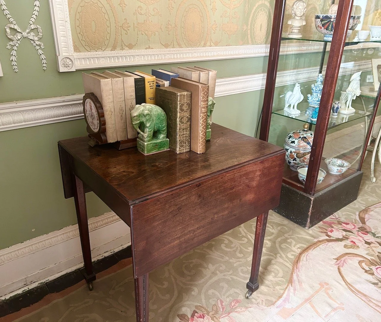 A side table in the Boudoir with green elephant bookends