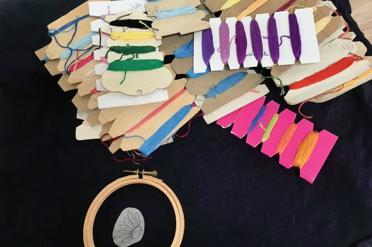 Choosing colours - from many enbroidery threads wound around cardboard