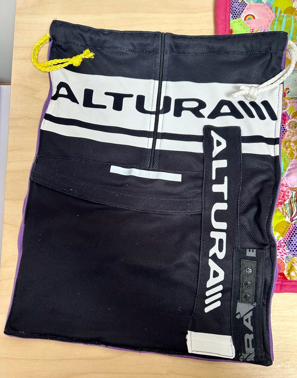 The front of the repurposed cycling top bag, complete with additional logos and reflective strips