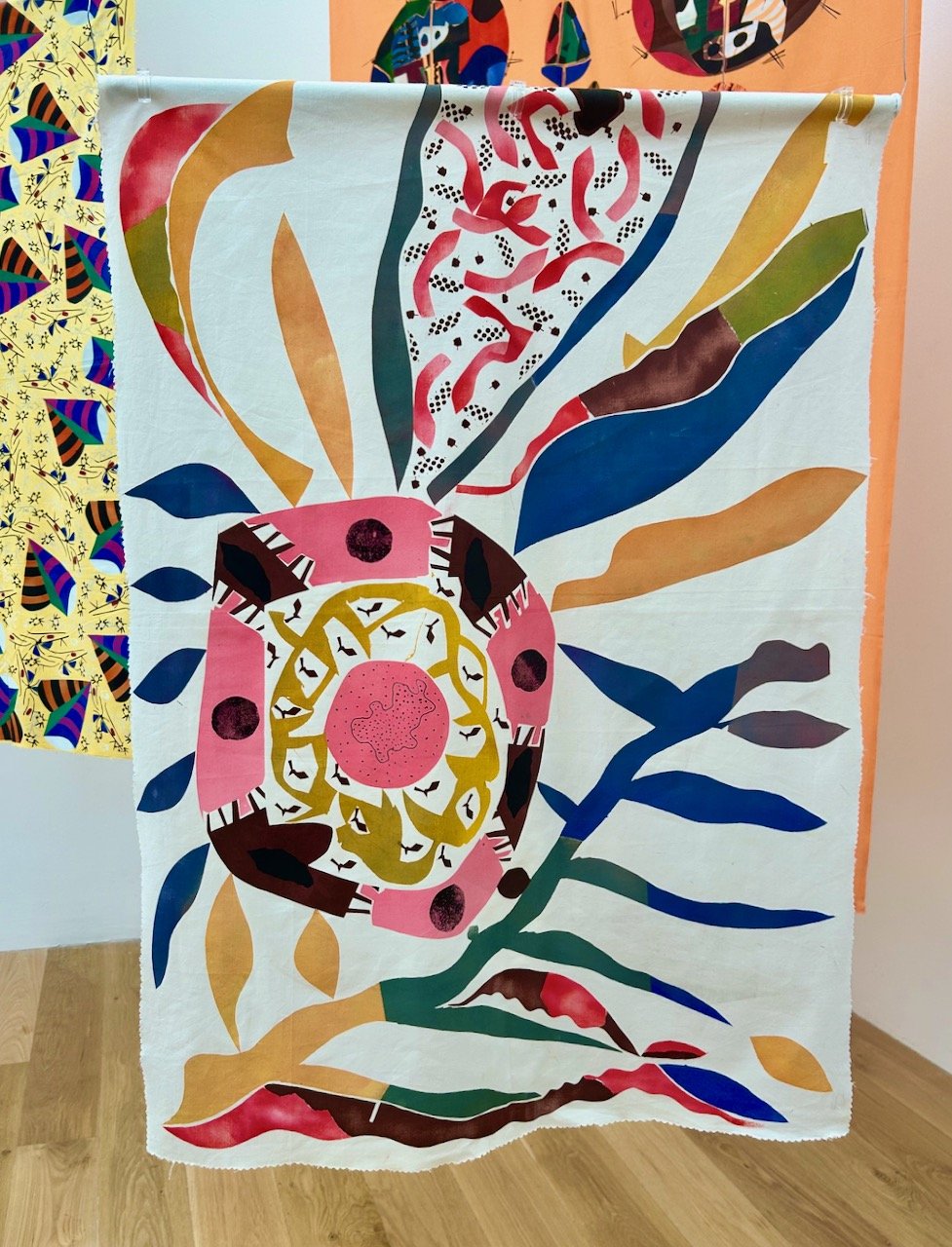 A textile with a circle and shapes emanating from it
